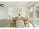 Dining room with wood table, six chairs, overhead lighting, and sliding glass doors to patio at 21907 Cellini Ave, Port Charlotte, FL 33952