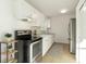 Efficient kitchen featuring stainless steel appliances, white cabinets and bright lighting at 21907 Cellini Ave, Port Charlotte, FL 33952