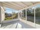 A relaxing screened patio provides shade and a view of the landscaped backyard at 21907 Cellini Ave, Port Charlotte, FL 33952