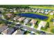 Aerial view of a charming single-Gathering home in a waterfront community with lush landscaping and mature trees at 236 Golden Harbour Trl, Bradenton, FL 34212