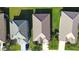 Overhead aerial view of the roofs of three homes showing roof condition, lush landscaping, and concrete driveways at 236 Golden Harbour Trl, Bradenton, FL 34212
