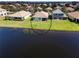 Aerial view of the home's backyard, adjacent to a serene lake in a well-manicured waterfront community at 236 Golden Harbour Trl, Bradenton, FL 34212