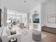 Open living room with white walls, hardwood floors, bright sunlight, a stylish white couch and elegant decor at 4152 Central Sarasota Pkwy # 727, Sarasota, FL 34238