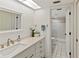 Bright bathroom featuring a modern vanity with storage, a decorative mirror, and a convenient shower at 5697 Sheffield Greene Cir # 51, Sarasota, FL 34235