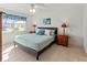 Cozy bedroom featuring a comfortable bed, tiled floors, and natural light from the window at 5697 Sheffield Greene Cir # 51, Sarasota, FL 34235