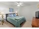 Inviting bedroom with a large bed, side tables, and a ceiling fan for a comfortable ambiance at 5697 Sheffield Greene Cir # 51, Sarasota, FL 34235