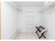 Walk-in closet equipped with multiple shelves and a folding rack to provide ample storage at 5697 Sheffield Greene Cir # 51, Sarasota, FL 34235
