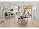 Bright dining room featuring tiled floors, a mirrored wall, and a view of the screened patio at 5697 Sheffield Greene Cir # 51, Sarasota, FL 34235