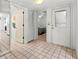 Spacious entryway with tile flooring, leading to various rooms and featuring a mirrored wall at 5697 Sheffield Greene Cir # 51, Sarasota, FL 34235