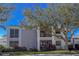 Two-story condo with screened in lanai, mature tree, and lush landscaping in a well-maintained neighborhood at 5697 Sheffield Greene Cir # 51, Sarasota, FL 34235