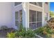 Charming home exterior featuring a screened patio and lovely landscaping at 5697 Sheffield Greene Cir # 51, Sarasota, FL 34235