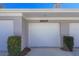 Attached garage door with unit number and manicured bushes at 5697 Sheffield Greene Cir # 51, Sarasota, FL 34235