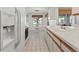 Bright kitchen with white countertops and cabinets, tile floor, and adjacent dining area with backyard view at 5697 Sheffield Greene Cir # 51, Sarasota, FL 34235