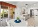 Bright kitchen with dining area, featuring modern appliances, white cabinets, and sliding glass door to a screened porch at 5697 Sheffield Greene Cir # 51, Sarasota, FL 34235