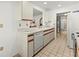 The kitchen features a double basin sink, ample countertop space, and white appliances, including a dishwasher at 5697 Sheffield Greene Cir # 51, Sarasota, FL 34235