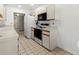 This kitchen features a refrigerator, oven, microwave and tile flooring at 5697 Sheffield Greene Cir # 51, Sarasota, FL 34235