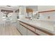 Bright kitchen featuring ample counter space, white cabinetry with wood trim, and a modern dishwasher at 5697 Sheffield Greene Cir # 51, Sarasota, FL 34235
