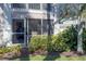 Charming screened patio with comfortable seating and lush landscaping offering a relaxing outdoor space at 5697 Sheffield Greene Cir # 51, Sarasota, FL 34235