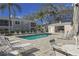 Relaxing community pool with ample seating and lush landscaping in a well-maintained residential area at 5697 Sheffield Greene Cir # 51, Sarasota, FL 34235