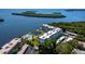 Aerial view of condo complex with boat docks, parking, and pool overlooking bay at 605 Sutton Pl # 205, Longboat Key, FL 34228