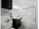 Bathroom features a shower-tub combination, dark vanity, and nautical accents at 605 Sutton Pl # 205, Longboat Key, FL 34228