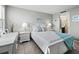 Bright bedroom with light walls, tile flooring, and coastal decor at 605 Sutton Pl # 205, Longboat Key, FL 34228