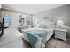 Cozy bedroom featuring tile floors, white furniture, and a view of the outdoors at 605 Sutton Pl # 205, Longboat Key, FL 34228