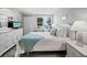 Relaxing bedroom features light walls, tile floor, and sunny window views at 605 Sutton Pl # 205, Longboat Key, FL 34228