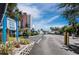 Exterior view of Longboat Harbour showcasing tropical landscaping, signage and convenient parking for residents and guests at 605 Sutton Pl # 205, Longboat Key, FL 34228