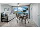 Dining area boasts water views and a daybed by large windows, perfect for relaxation at 605 Sutton Pl # 205, Longboat Key, FL 34228