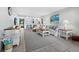 Inviting living room with serene decor and an open layout featuring a bar with seating at 605 Sutton Pl # 205, Longboat Key, FL 34228