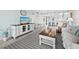 Relaxing living room features a TV, comfortable seating, and a bar with stools at 605 Sutton Pl # 205, Longboat Key, FL 34228