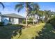 Backyard view showing mature landscaping, lush green lawn, and the home at 11422 Griffith Park Ter, Bradenton, FL 34211