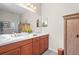 Bathroom features a double vanity, a large mirror, tile floors, and a bath tub with shower at 11422 Griffith Park Ter, Bradenton, FL 34211