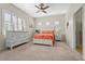 Bright bedroom features a ceiling fan, carpeted floor, shutters, and a white dresser at 11422 Griffith Park Ter, Bradenton, FL 34211