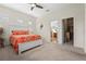Bright bedroom features a ceiling fan, carpeted floor, shutters, and a white dresser at 11422 Griffith Park Ter, Bradenton, FL 34211