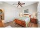 Bedroom features a ceiling fan, wood floors, shutters, and a large closet at 11422 Griffith Park Ter, Bradenton, FL 34211
