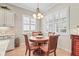 Charming breakfast nook area with a chandelier, windows with wooden shutters, and dining table at 11422 Griffith Park Ter, Bradenton, FL 34211