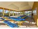 The community park shelter provides ample seating with blue picnic tables and an open design with palm tree views at 11422 Griffith Park Ter, Bradenton, FL 34211