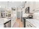Bright kitchen with stainless steel appliances, granite countertops, and ample cabinet space for storage and meal preparation at 11422 Griffith Park Ter, Bradenton, FL 34211