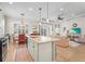 Open kitchen with granite counters, stainless steel appliances, pendant lights, and views into the living area at 11422 Griffith Park Ter, Bradenton, FL 34211