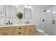 Updated bathroom with double sink vanity, modern fixtures, and glass shower at 3348 S Seclusion Dr, Sarasota, FL 34239