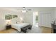 Bright bedroom with a ceiling fan, a window view and a door to the backyard at 3348 S Seclusion Dr, Sarasota, FL 34239