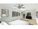 This bedroom offers lots of light, hard wood floors, and neutral-toned décor at 3348 S Seclusion Dr, Sarasota, FL 34239