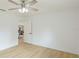 Bright bedroom featuring wood floors and a doorway view at 3348 S Seclusion Dr, Sarasota, FL 34239