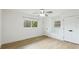 Sunlit bedroom featuring wood floors, a ceiling fan and a window view at 3348 S Seclusion Dr, Sarasota, FL 34239