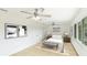 This bedroom offers lots of light, hard wood floors, and neutral-toned décor at 3348 S Seclusion Dr, Sarasota, FL 34239