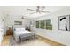 This bedroom offers lots of light, hard wood floors, and neutral-toned décor at 3348 S Seclusion Dr, Sarasota, FL 34239