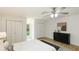 Bedroom with a ceiling fan, light wood floors, and two closets at 3348 S Seclusion Dr, Sarasota, FL 34239