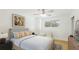 Well-lit bedroom with a window view, hardwood floors and updated furniture at 3348 S Seclusion Dr, Sarasota, FL 34239